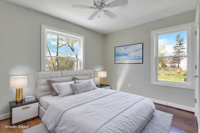 bedroom featuring baseboards, ceiling fan, and wood finished floors