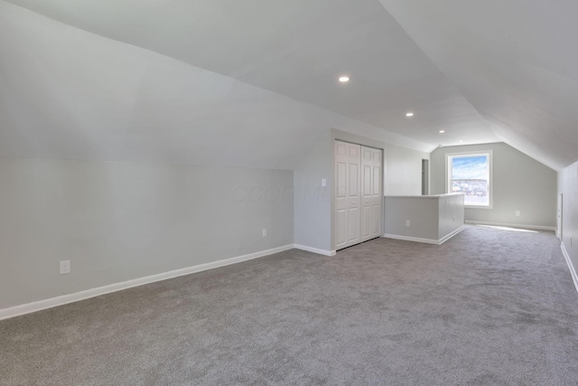 additional living space with carpet floors, recessed lighting, baseboards, and lofted ceiling