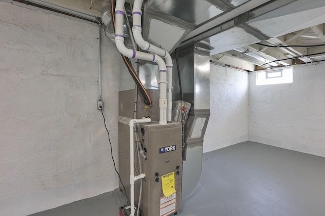 utility room featuring heating unit