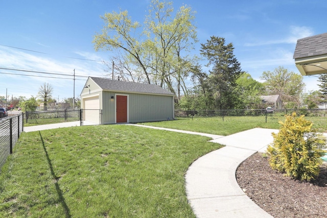 view of yard featuring an outdoor structure, fence, and a detached garage