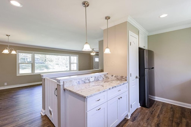 kitchen featuring freestanding refrigerator, ornamental molding, baseboards, white cabinets, and dark wood finished floors