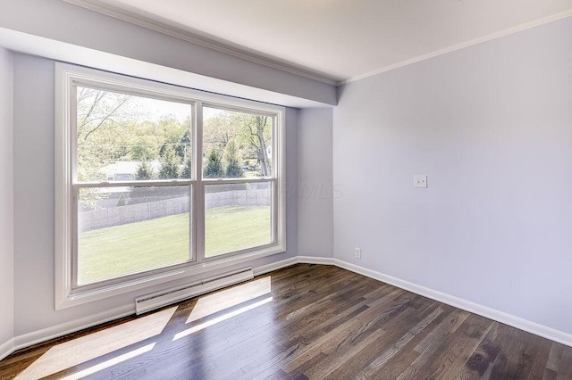 empty room featuring baseboards, plenty of natural light, dark wood-type flooring, and a baseboard radiator