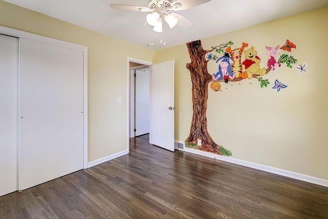 unfurnished bedroom featuring baseboards, ceiling fan, wood finished floors, and visible vents