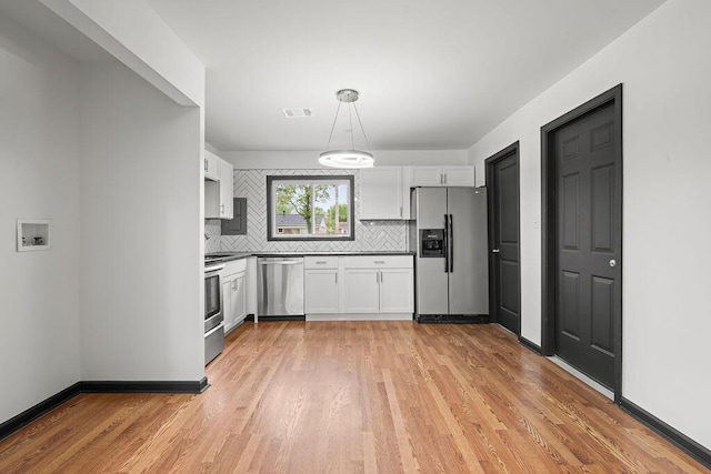 1727 Niagara Rd, Columbus, OH 43227 - kitchen with appliances with stainless steel finishes, backsplash, and white cabinets