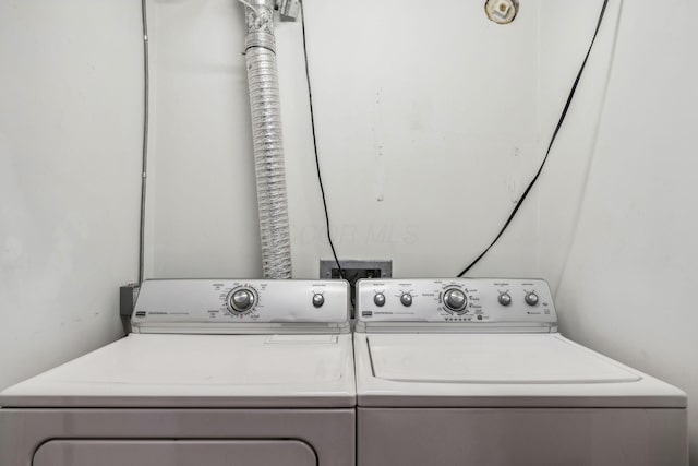 washroom with independent washer and dryer and laundry area
