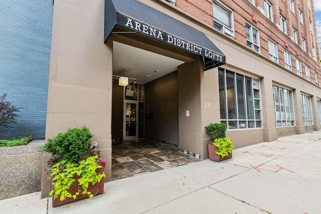 entrance to property featuring brick siding