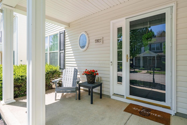 view of exterior entry with a porch