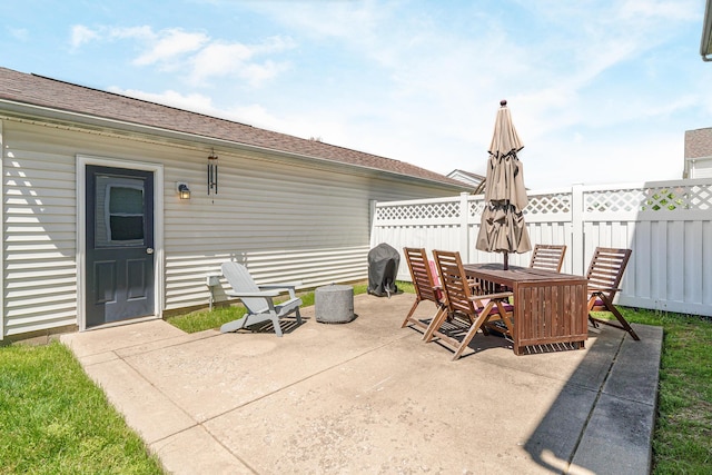 view of patio with fence and outdoor dining space
