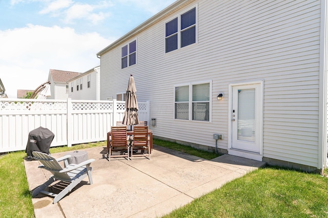 back of house with fence and a patio area