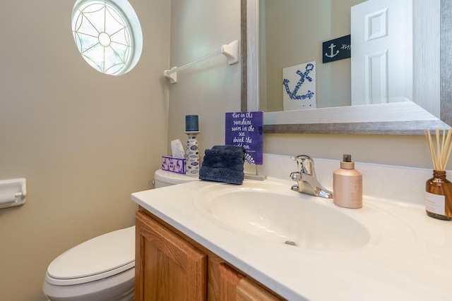 bathroom featuring toilet and vanity