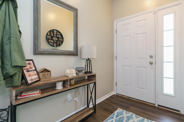 entrance foyer featuring baseboards and dark wood-style floors