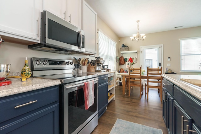 kitchen with an inviting chandelier, light countertops, blue cabinetry, and stainless steel appliances