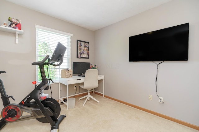 carpeted home office featuring baseboards