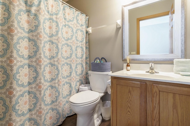 bathroom with vanity, a shower with shower curtain, and toilet