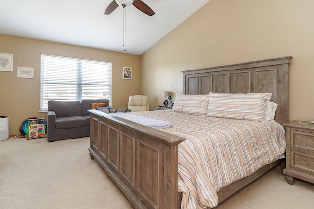 bedroom with a ceiling fan, lofted ceiling, and light carpet