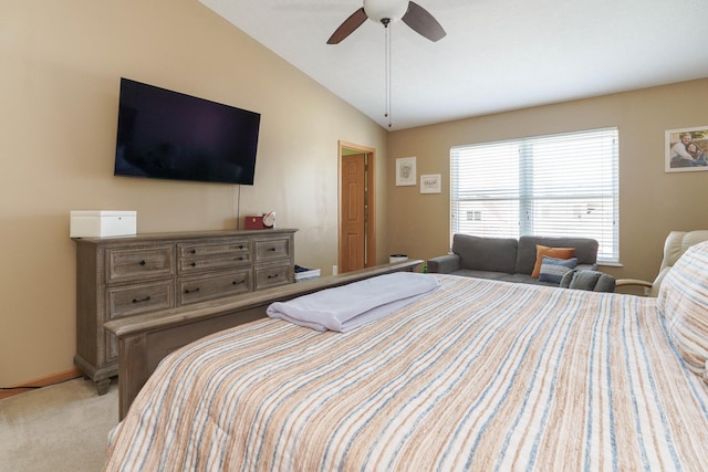 bedroom with baseboards, ceiling fan, light colored carpet, and lofted ceiling
