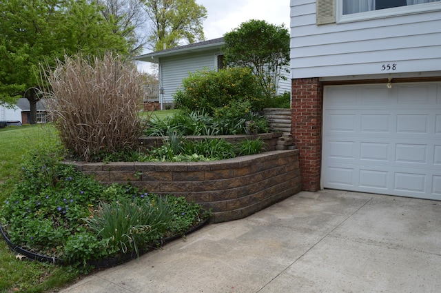 view of side of property featuring an attached garage and driveway