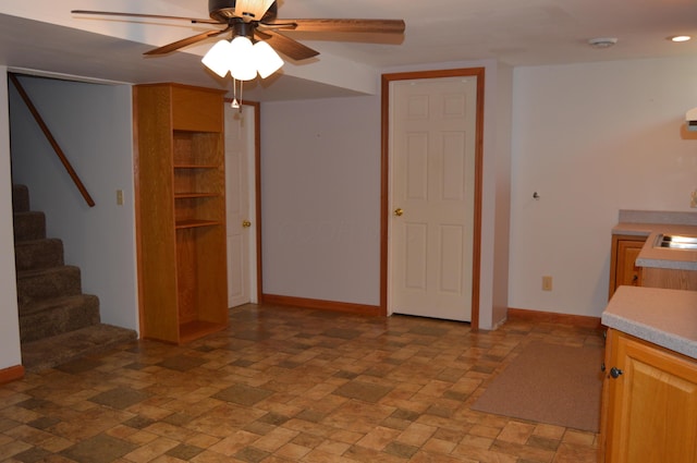 unfurnished living room with baseboards, a ceiling fan, recessed lighting, and stairway