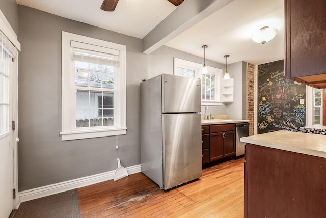kitchen featuring plenty of natural light, a sink, light wood-style flooring, and appliances with stainless steel finishes