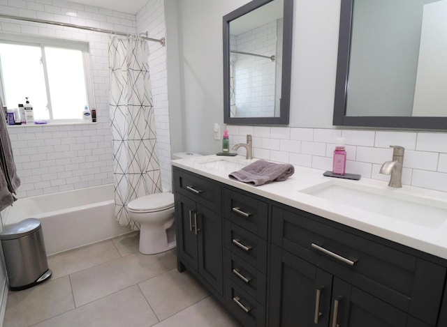 full bath featuring a sink, shower / bath combo, toilet, and double vanity