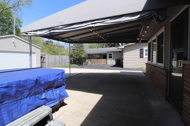 view of patio / terrace with fence and an outdoor structure