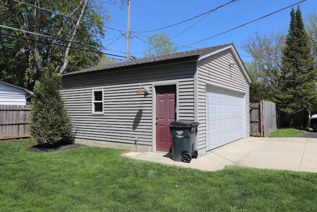 detached garage featuring fence