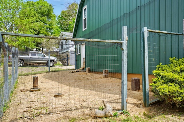 view of side of home featuring fence