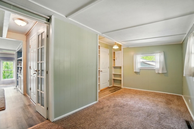 interior space featuring carpet flooring, baseboards, and visible vents