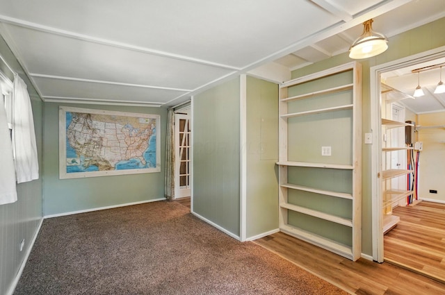 interior space featuring baseboards and wood finished floors