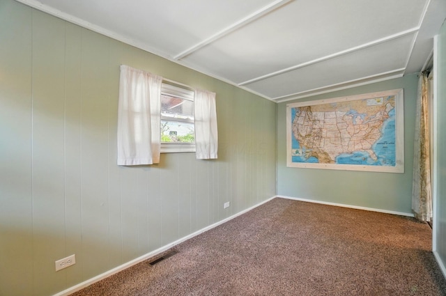 empty room featuring baseboards, carpet flooring, and visible vents