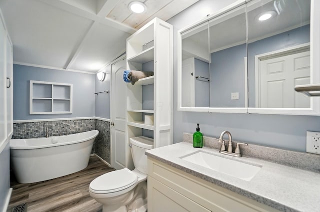 bathroom featuring wainscoting, wood finished floors, vanity, toilet, and a soaking tub