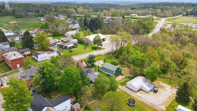 drone / aerial view featuring a residential view and a forest view