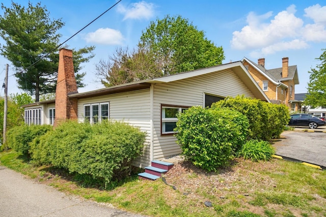 view of home's exterior with a chimney