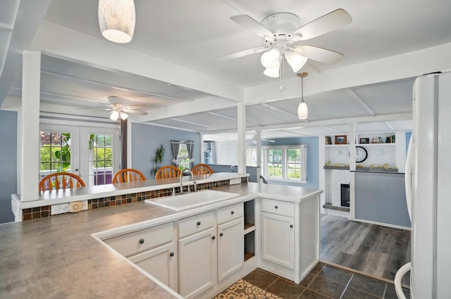 kitchen featuring french doors, freestanding refrigerator, ceiling fan, and dark tile patterned flooring