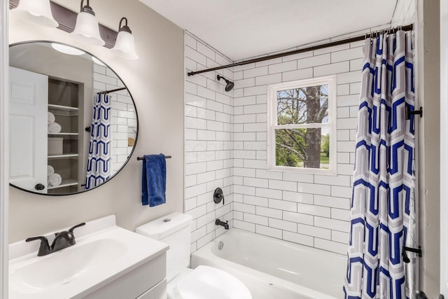 full bath featuring vanity, shower / bath combo with shower curtain, and toilet