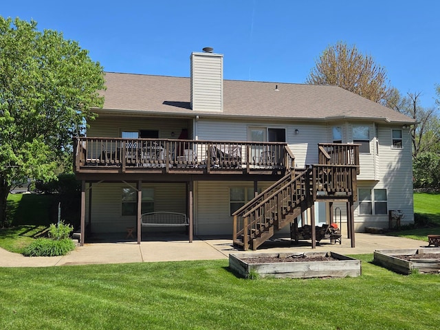 back of house with a fire pit, a patio area, a wooden deck, and a yard