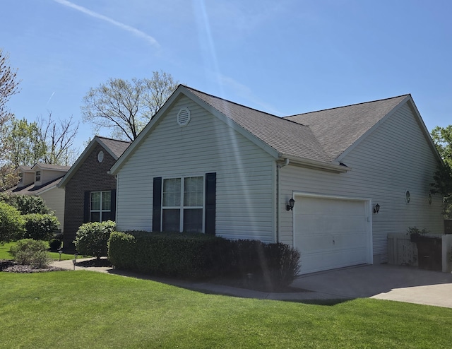 view of home's exterior with a lawn, a garage, a shingled roof, and driveway