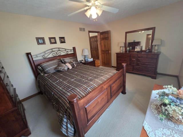 carpeted bedroom with baseboards, ceiling fan, and visible vents