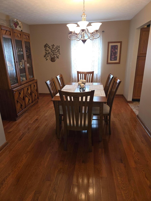 dining area with an inviting chandelier and wood finished floors