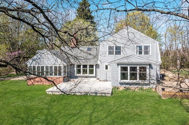 back of property featuring a yard and a patio area