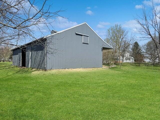 view of pole building with a yard