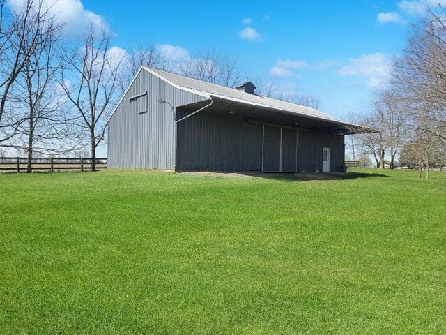 view of pole building featuring a yard and fence