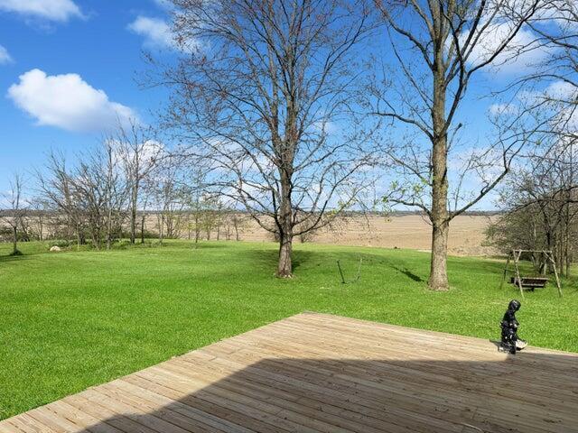 wooden deck with a lawn