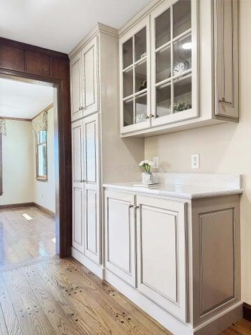 bar with baseboards and light wood finished floors