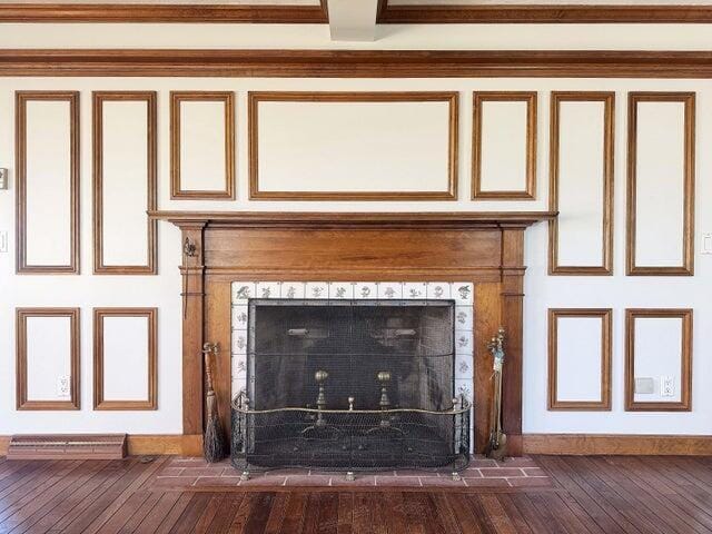 interior details with wood finished floors and a fireplace
