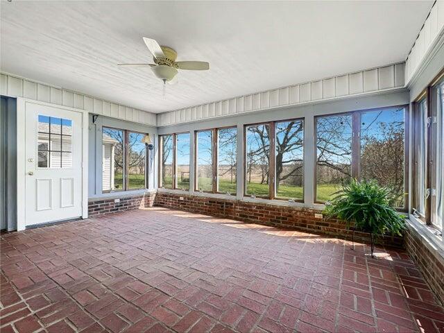 unfurnished sunroom with brick floor