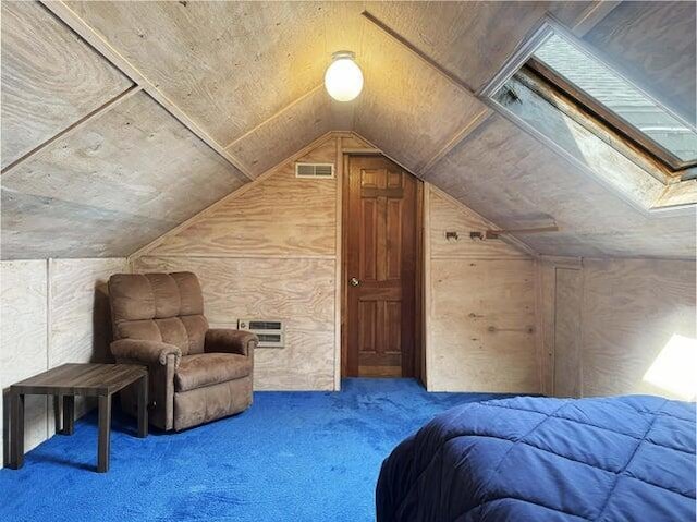 carpeted bedroom featuring visible vents and lofted ceiling