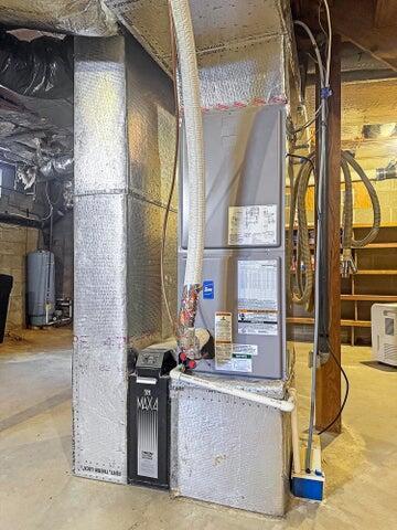 utility room featuring water heater