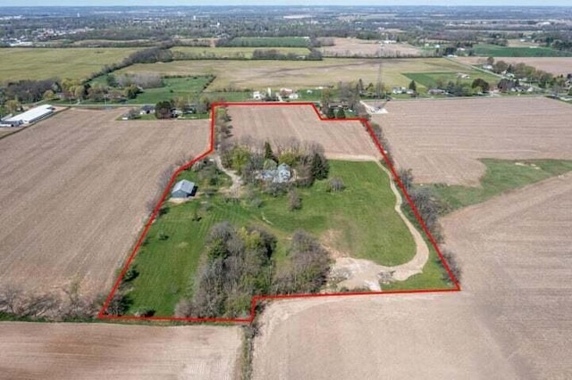 birds eye view of property with a rural view
