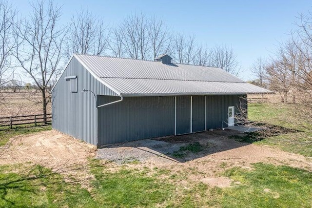 view of outbuilding featuring fence
